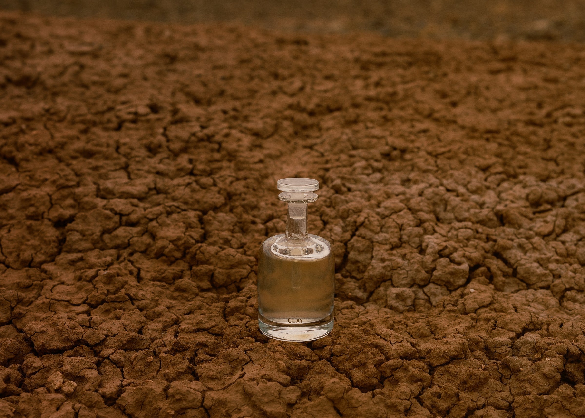 CLAY hand blown bottle on a wide cracked clay plain