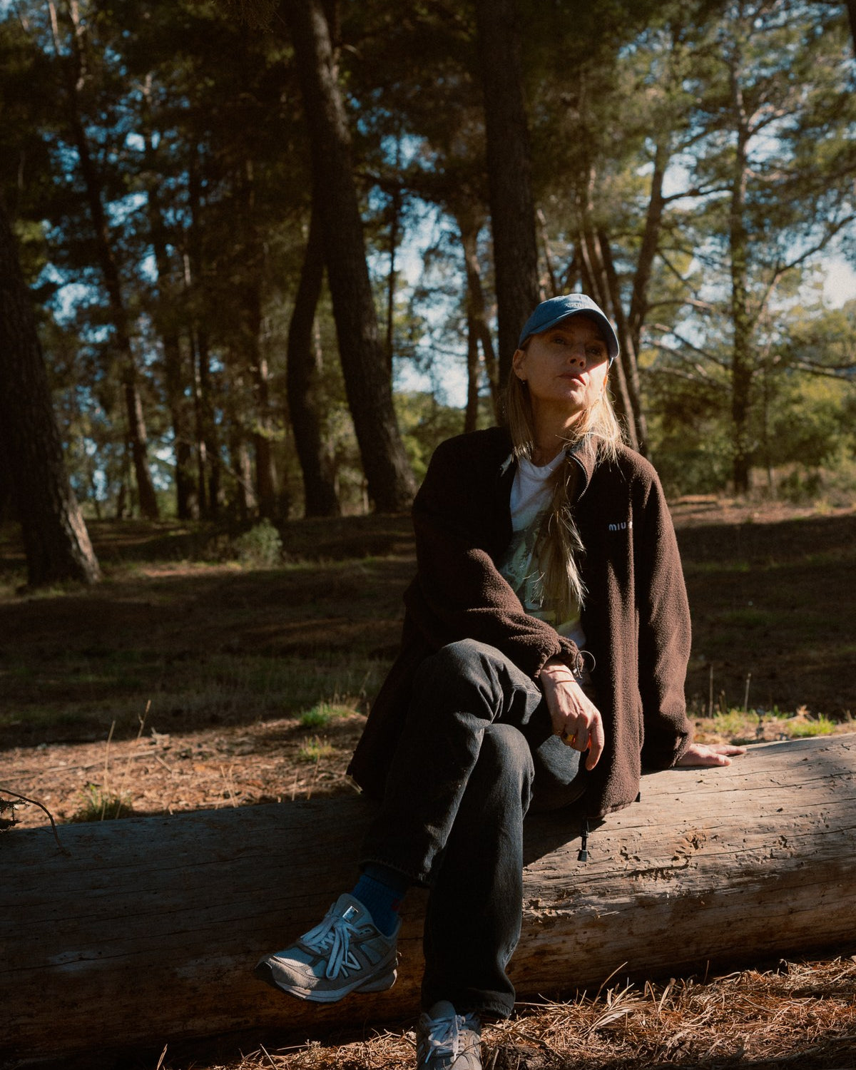 Lyn Harris sitting on a felled pine trunk