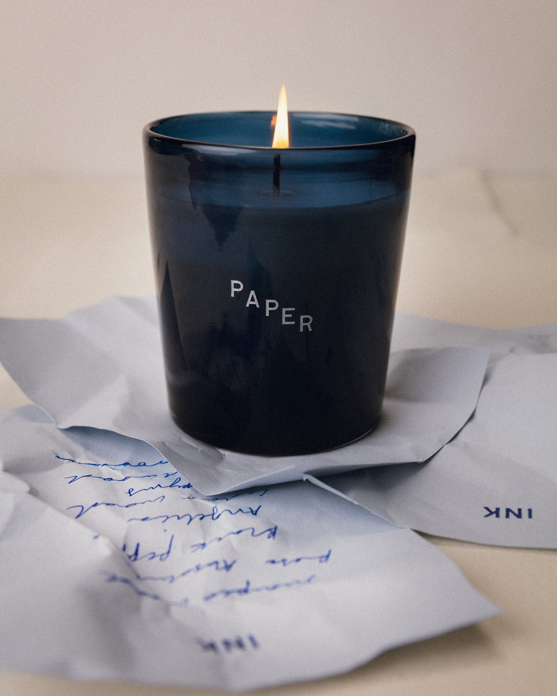 Ink on Paper: Paper candle lit on handwritten letters