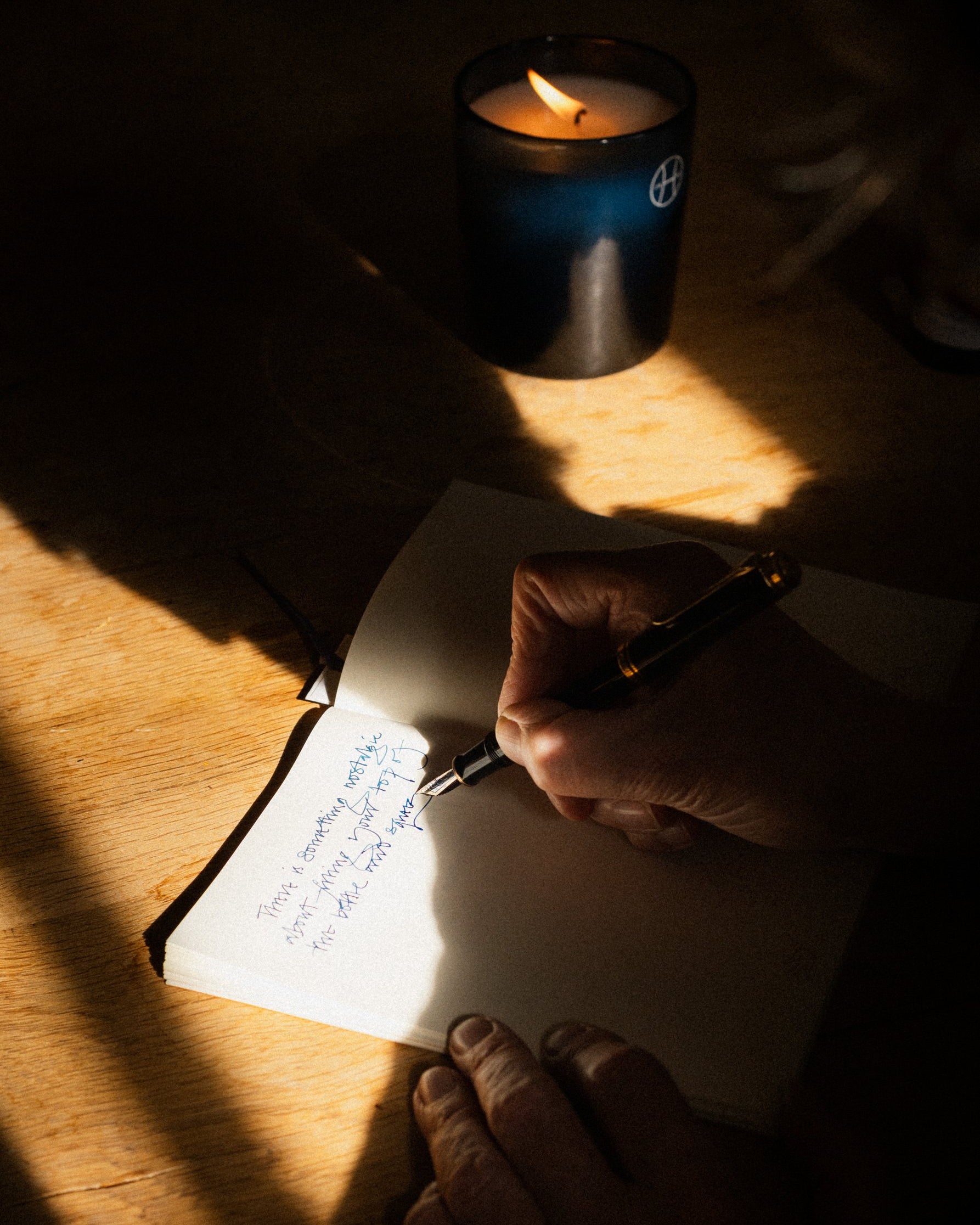 A letter being written by candlelight