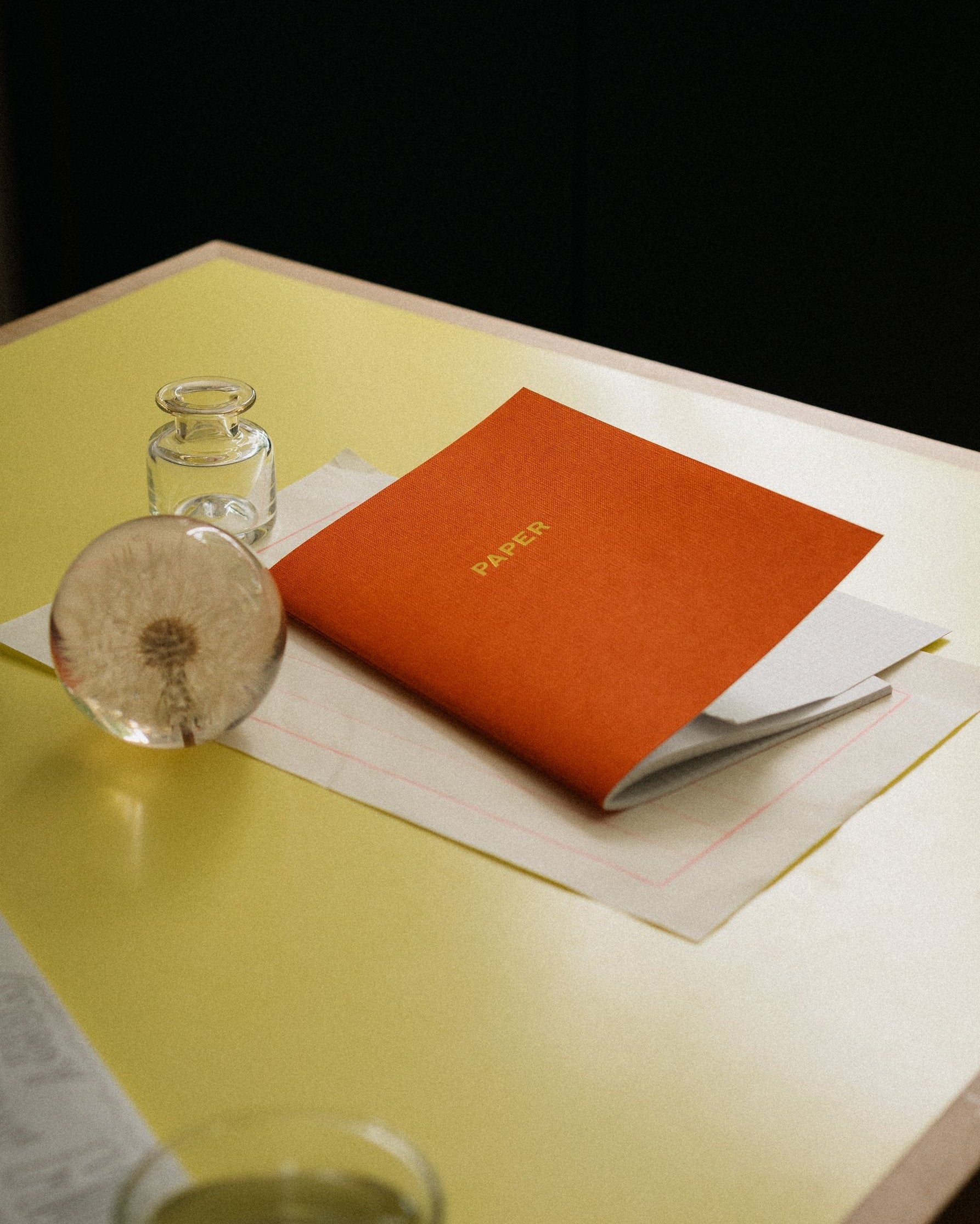 Ink on Paper: Paper notebook on a yellow desk