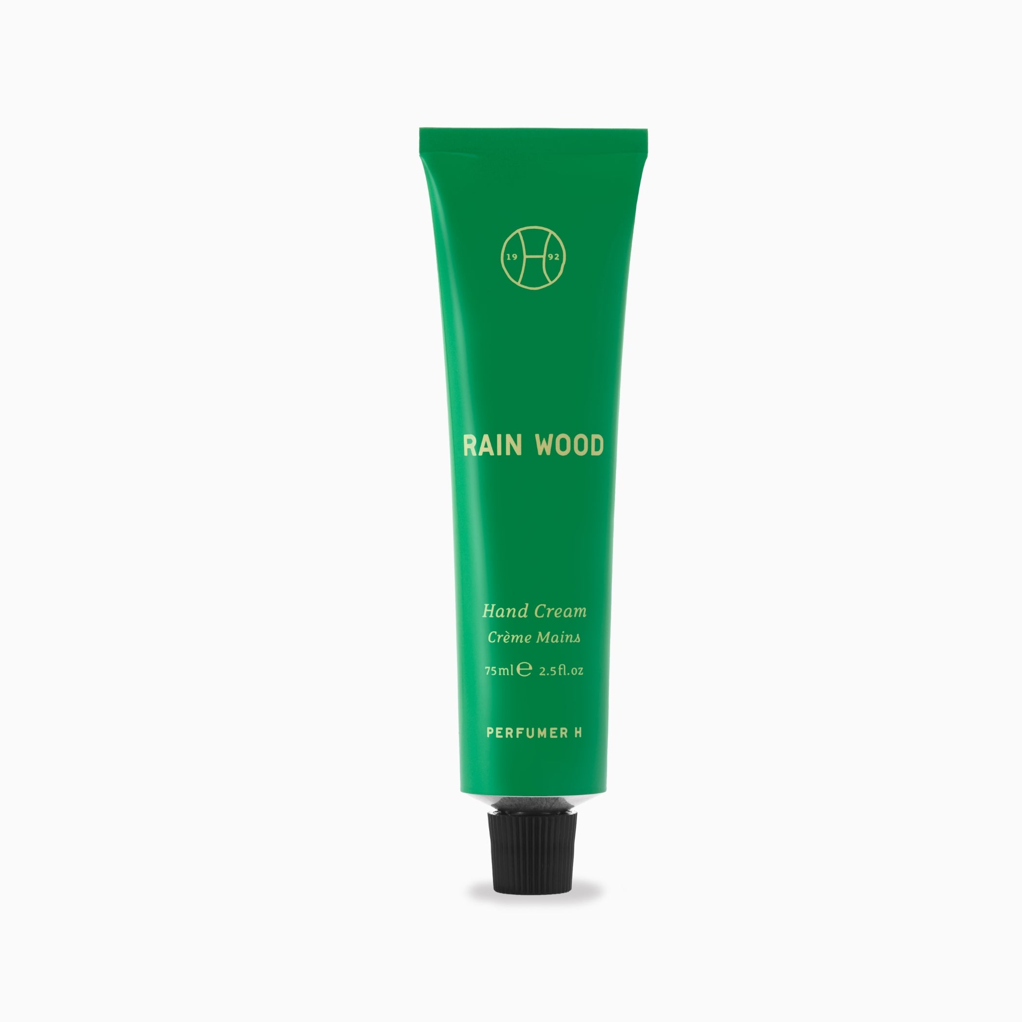 Rain Wood Hand Cream 75ml in its green aluminium tube with black ribbed cap, front view